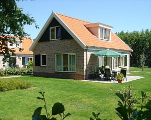 Terrace with parasol at 6-person vacation home with sauna, De Koog, Texel