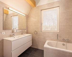 Enjoy the sunny terrace of Villa 8 in De Koog, Texel, a luxury vacation home on the Wadden Islands with beautiful views of nature.