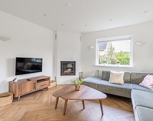 Cozy living room of Stappeland 197 in De Koog, Texel with modern furnishings and fireplace.