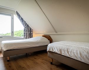 Cozy bedroom with two single beds in Villa 304, De Koog, Texel on the Wadden Islands.
