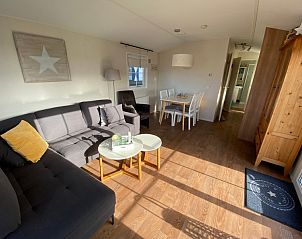 Spacious interior of Chalet Bregkoog 255 in De Koog, Texel with dining area and comfortable sitting area, perfect for family vacations on the Wadden Islands.