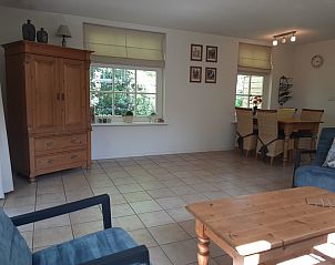 Spacious dining room in Pauwenhof Texel vacation home in De Koog with lots of natural light.