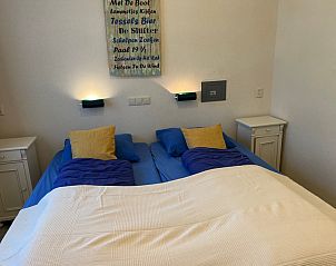 Bedroom in Landgoed Springtij - Koetshuis 3, vacation home De Koog, Texel with double bed and atmospheric lighting.