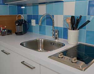 Compact kitchenette in Grand Hotel Opduin - Holiday home A, De Koog, Texel with modern amenities on the Wadden Islands.