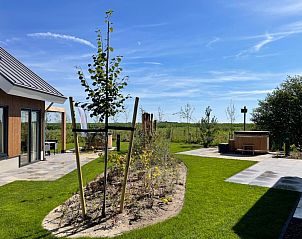 View from Duinvilla Wellness 6, Texel, with spacious garden and natural surroundings.