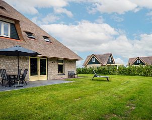 Terrace with parasol at Holiday home in De Koog, Texel, ideal for relaxation.