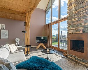 Comfortable sitting area with fireplace in Holiday home in De Koog Texel, overlooking the Wadden Islands garden.