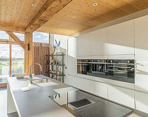Modern kitchen with island in Holiday home in De Koog Texel, perfect for culinary delights on the Wadden Islands.