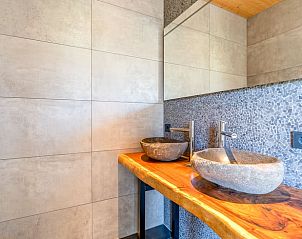 Elegant bathroom with natural stone sinks in Holiday home in De Koog Texel, ideal for relaxation on the Wadden Islands.