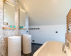Modern bathroom with double sinks in Holiday home in De Koog Texel, offers comfort on the Wadden Islands.