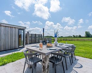 Outdoor dining area overlooking nature in Holiday home in De Koog Texel, perfect for dining on the Wadden Islands.