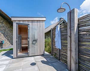 External sauna with outdoor shower in Holiday home in De Koog Texel, for a wellness experience on the Wadden Islands.