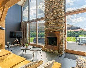 Modernly furnished interior space with large windows in Holiday home in De Koog, Texel.