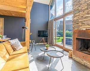 Stylish living room with art and fireplace in Holiday home in De Koog, Texel.