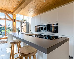 Sleek kitchen with modern appliances in Holiday home in De Koog, Texel.