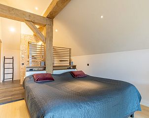 Cozy bedroom with wooden beams in Holiday cottage in De Koog, Texel.