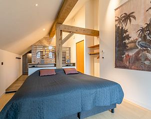 Spacious bedroom with art and wooden details in Holiday home in De Koog, Texel.