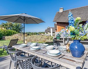Cozy terrace with flowers and parasol at Holiday home in De Koog, Texel.