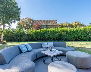 Spacious terrace with comfortable seating at Holiday home in De Koog, Texel.