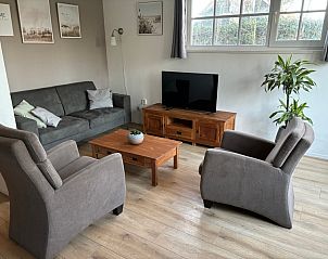 Cozy living room of Stormvogel, vacation home in De Koog, Texel with comfortable seating area.