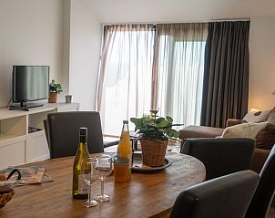 Cozy dining area in Bungalow 2, De Koog, Texel, overlooking the terrace and natural light.