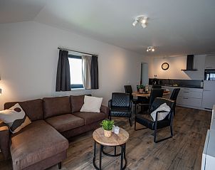 Spacious living room with open kitchen in Bungalow 2, De Koog, Texel, ideal for family gatherings.