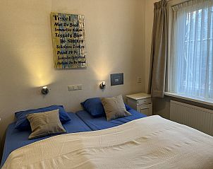 Bedroom in Koetshuis 3 vacation home, De Koog, Texel with double bed and atmospheric lighting.