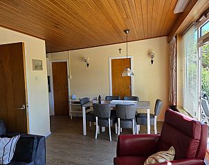 Dining area in Bungalowpark De Nagtegaal - Bungalow 47, De Koog, Texel, with large dining table.