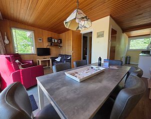 Open living space in Bungalowpark De Nagtegaal - Bungalow 47, Texel, with dining and sitting area.