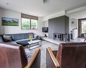 Cozy living room in Orchismient 20, vacation home De Koog, Texel with sitting area and fireplace.