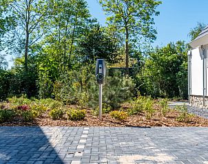 Front of Holiday Home in Den Burg, Texel, with modern facade and parking lot.