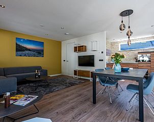 Cozy indoor area of cottage in Den Burg, Texel, overlooking terrace.