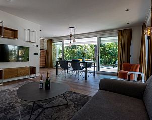 Dining room of cottage in Den Burg, Texel, with large windows to the garden.