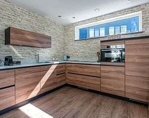 Bedroom in Holiday Home in Den Burg, Texel, with double bed and art on the wall.