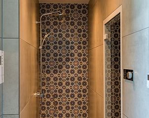 Steam room in Holiday cottage in Den Burg, Texel, with colorful tiles.