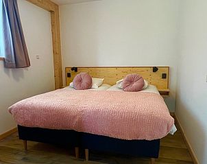 Comfortable bedroom with pink details in Hoeve Consensus Texel vacation home, Den Burg
