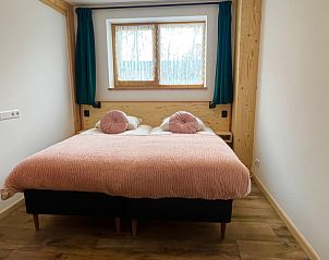 Cozy bedroom with large window in Hoeve Consensus Texel vacation home, Den Burg