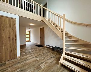 Spacious hall with wooden stairs in Hoeve Consensus Texel vacation home, Den Burg, Texel