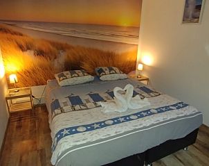 Comfortable bedroom in Hospitable vacation home Den Burg, Texel, with beach theme for a restful night's sleep.