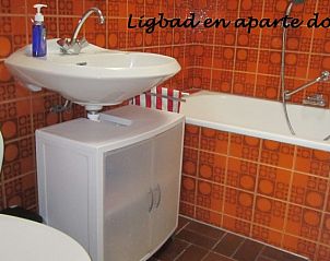 Stylish bathroom with bathtub in Hospitable vacation home Den Burg, Texel, for ultimate relaxation on the Wadden Islands.
