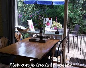 Dining area overlooking the garden in Hospitable vacation home Den Burg, Texel, for a homely feeling on the Wadden Islands.