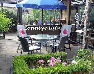 Sunny garden with seating area at Hospitable vacation home in Den Burg, Texel, ideal for outdoor living on the Wadden Islands.