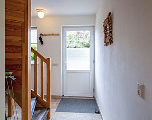 Entrance with stairs in Cottage in Den Burg, Texel, vacation home with wooden details.