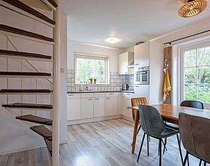 Cozy kitchen in Holiday home 5 Persoons Den Burg Texel with dining area.