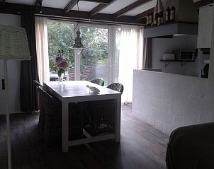 Eetkamer met uitzicht op tuin in De Kikker bungalow, Den Burg, Texel.