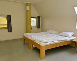 Lichte slaapkamer in Vakantiewoning - Molenhuizen, Den Burg, Texel met tweepersoonsbed en grote ramen.