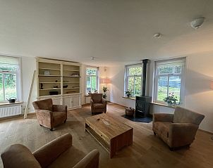 Bright living room in 44 - Aldubo Landhuis, vacation home in Den Burg, Texel, with large windows.