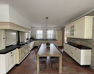 Spacious kitchen in 44 - Aldubo Landhuis, Den Burg, Texel, with large dining table and modern appliances.