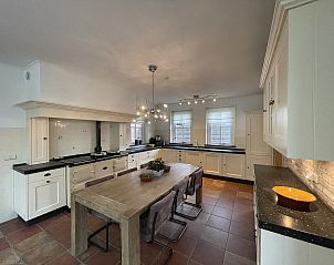 Country kitchen in 44 - Aldubo Landhuis, Den Burg, Texel, with wooden dining table and light cabinets.