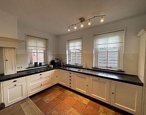 Kitchen with a view in 44 - Aldubo Landhuis, Den Burg, Texel, equipped with modern facilities.